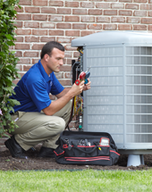 Man repairing a central air conditioner outside a home